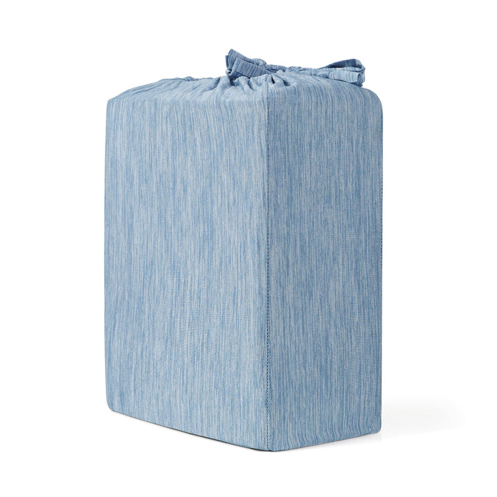 Blue textured cube-shaped ottoman on a white background