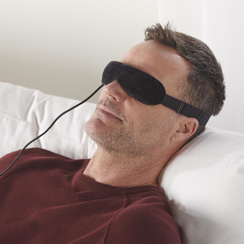 Man relaxing with Wizard Research electric heated dry eye relief mask for eye therapy